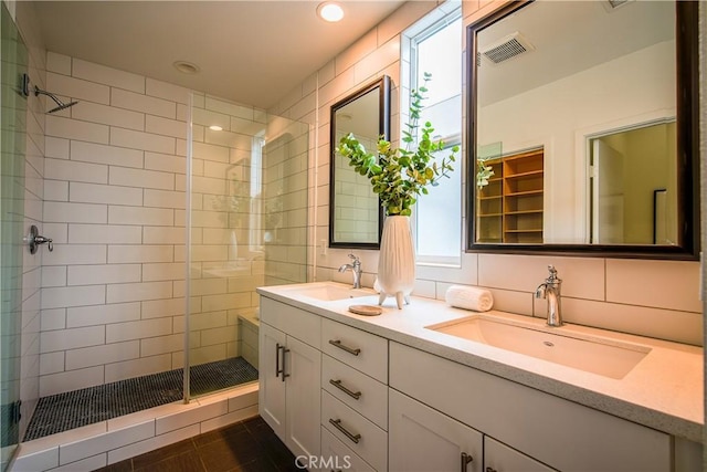 bathroom with tile patterned floors, plenty of natural light, and a shower with shower door