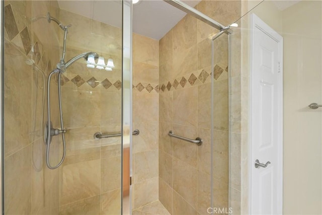 bathroom with a shower with door