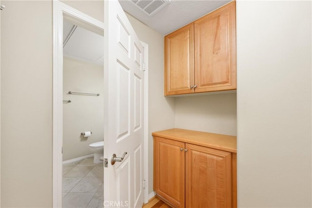 bathroom with tile patterned flooring and toilet