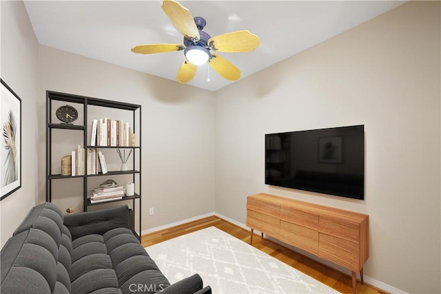 living room featuring ceiling fan and wood-type flooring