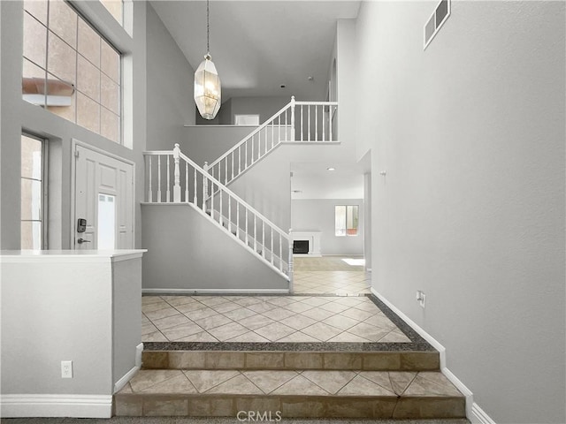 staircase with a towering ceiling