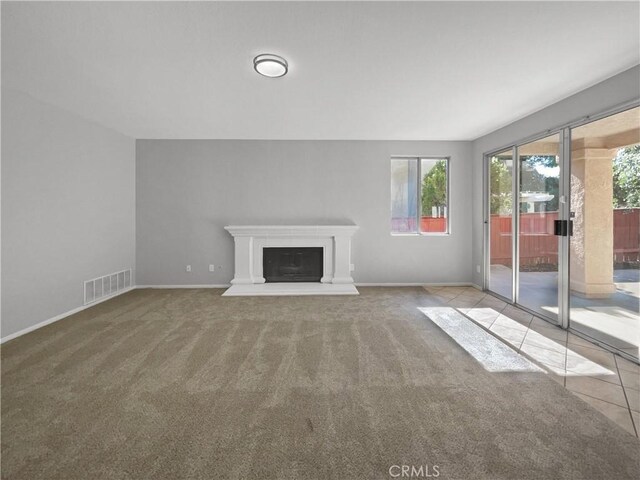 unfurnished living room featuring light colored carpet