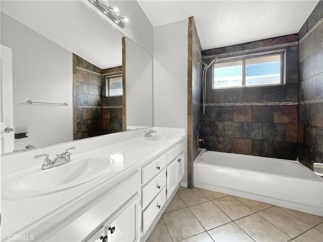 bathroom featuring vanity, tile patterned floors, and tiled shower / bath