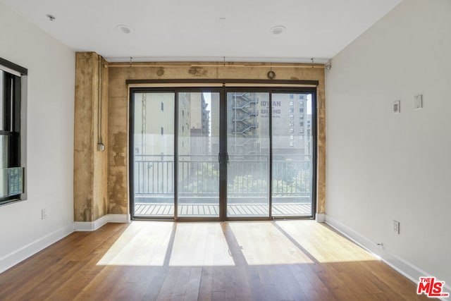 unfurnished room featuring hardwood / wood-style flooring