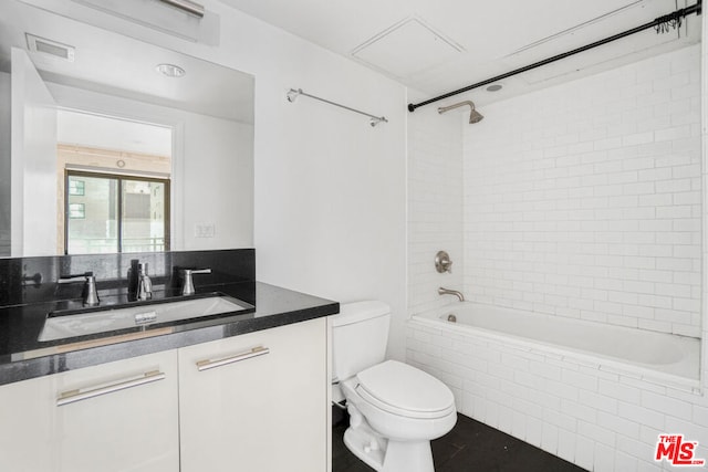 full bathroom with vanity, toilet, and tiled shower / bath