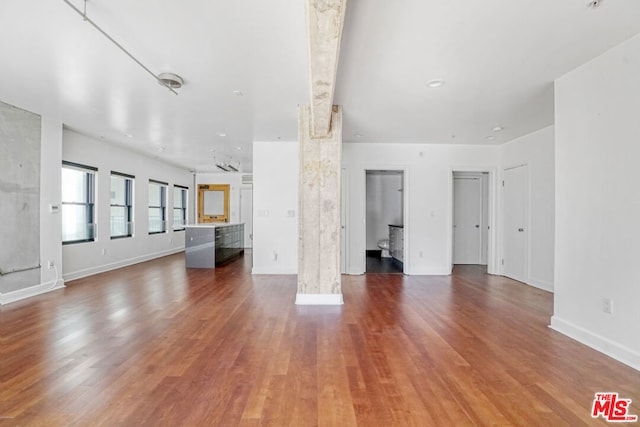 unfurnished living room featuring hardwood / wood-style flooring