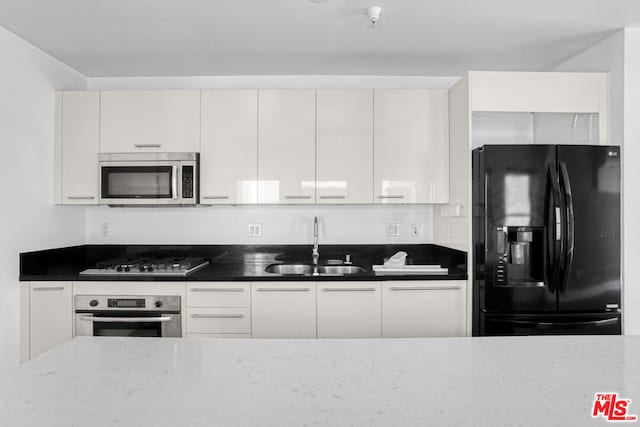 kitchen featuring white cabinetry, appliances with stainless steel finishes, and sink