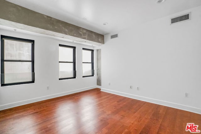 empty room with wood-type flooring