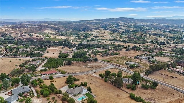 birds eye view of property with a mountain view