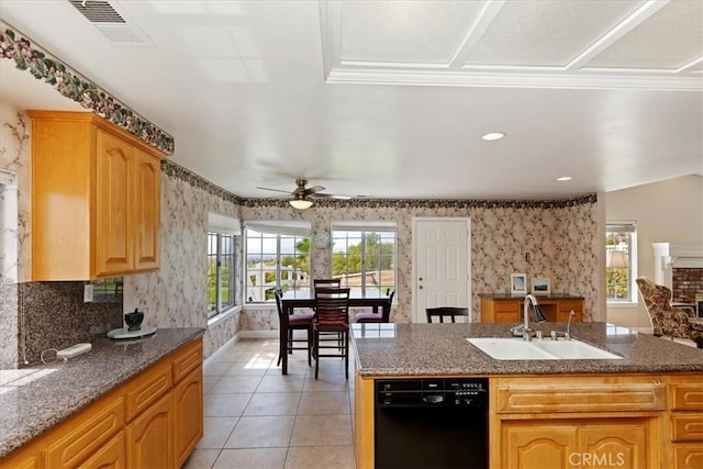 kitchen featuring a center island, black dishwasher, sink, light tile patterned flooring, and ceiling fan