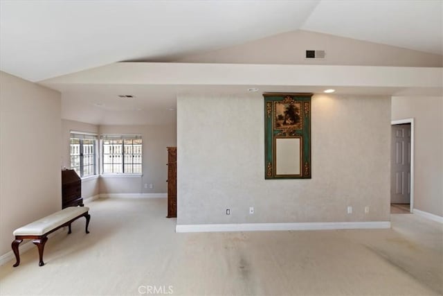 interior space featuring vaulted ceiling and carpet