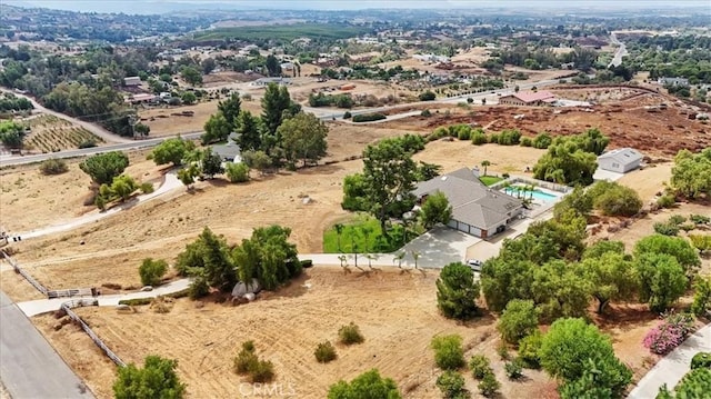 birds eye view of property with a rural view