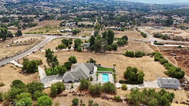 birds eye view of property with a rural view