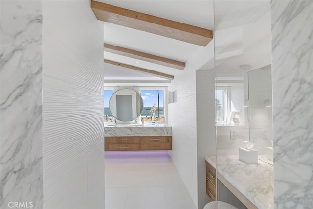 bathroom featuring vanity, tile patterned flooring, tile walls, and vaulted ceiling with beams