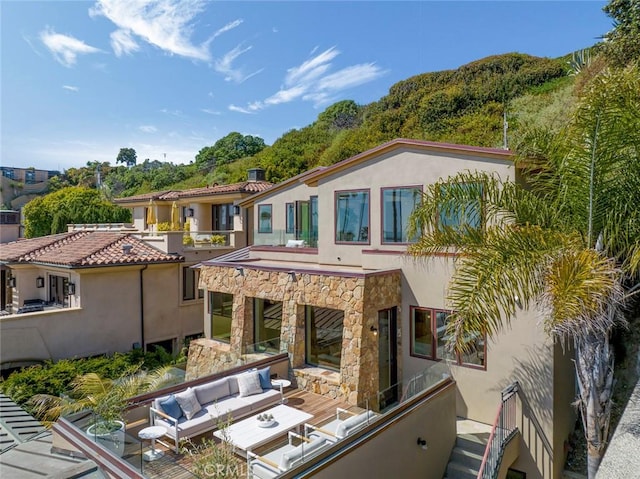 rear view of property with an outdoor hangout area