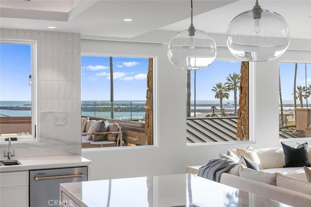 dining room with a water view and sink