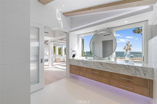 bathroom with vanity and lofted ceiling with beams