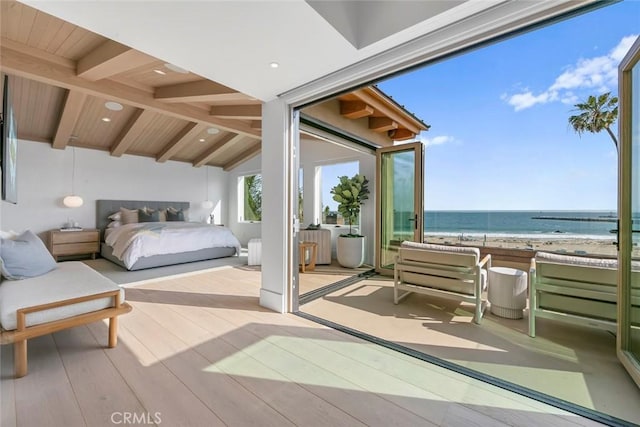 bedroom with a beach view, vaulted ceiling with beams, a water view, light hardwood / wood-style flooring, and access to outside