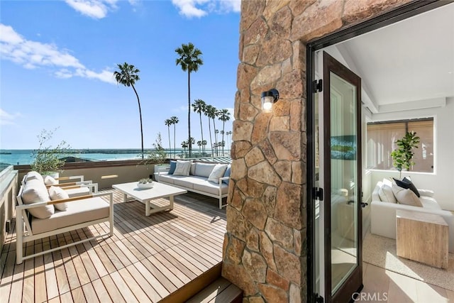 balcony featuring a water view and an outdoor hangout area