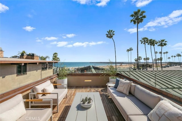 balcony with a water view and an outdoor living space