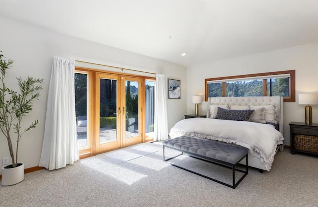 bedroom with access to outside, light colored carpet, and french doors