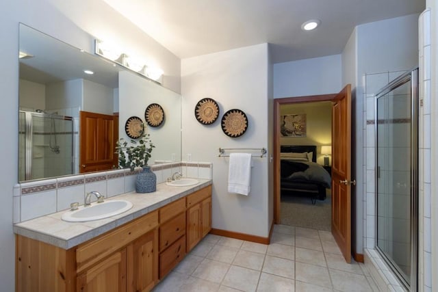 bathroom featuring a shower with door, vanity, tile patterned floors, and backsplash