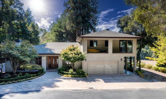 view of front of home with a garage and a balcony