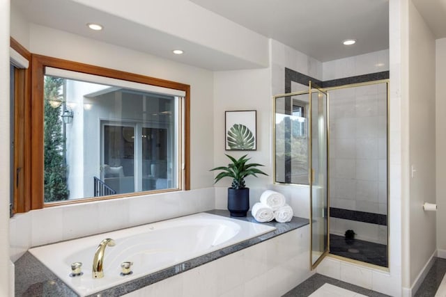 bathroom featuring shower with separate bathtub