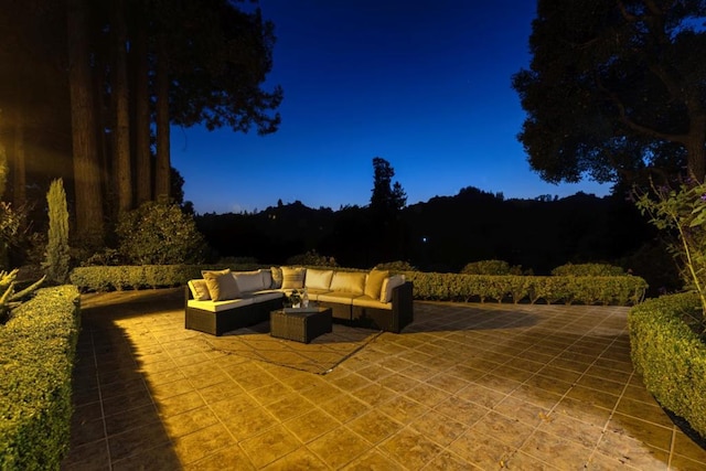 patio at twilight featuring an outdoor hangout area