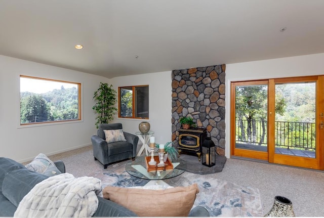 carpeted living room featuring a wood stove