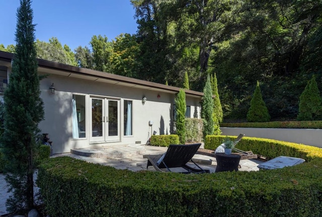 rear view of house featuring a patio and french doors