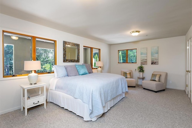 bedroom with multiple windows and carpet