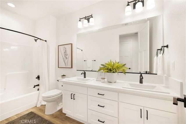 full bathroom with wood-type flooring, vanity, toilet, and shower / bath combo with shower curtain