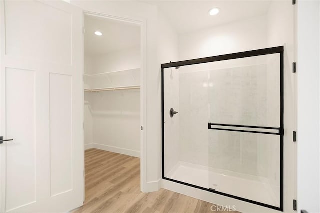 bathroom featuring walk in shower and hardwood / wood-style flooring