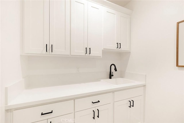 interior space featuring sink and white cabinets