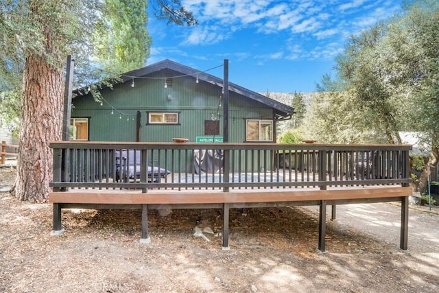 rear view of house featuring a deck