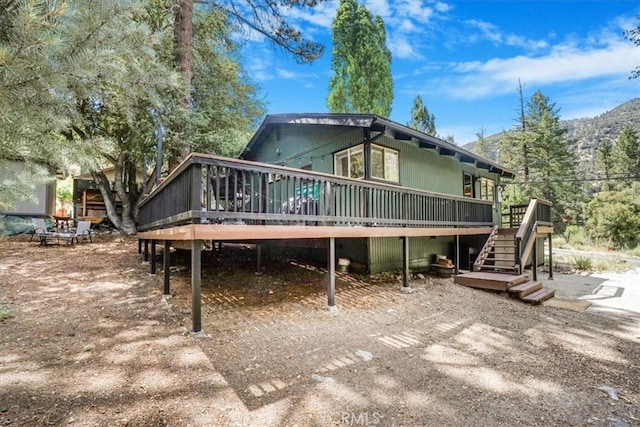 back of house with a deck with mountain view