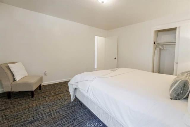 bedroom featuring a closet and dark colored carpet