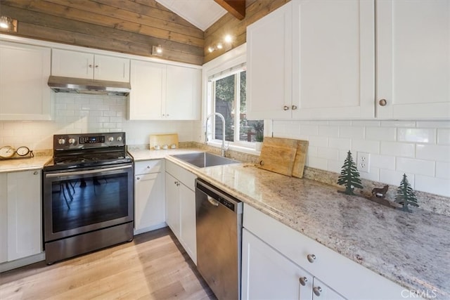 kitchen featuring white cabinets, vaulted ceiling with beams, sink, ventilation hood, and appliances with stainless steel finishes