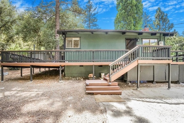 rear view of house with a wooden deck