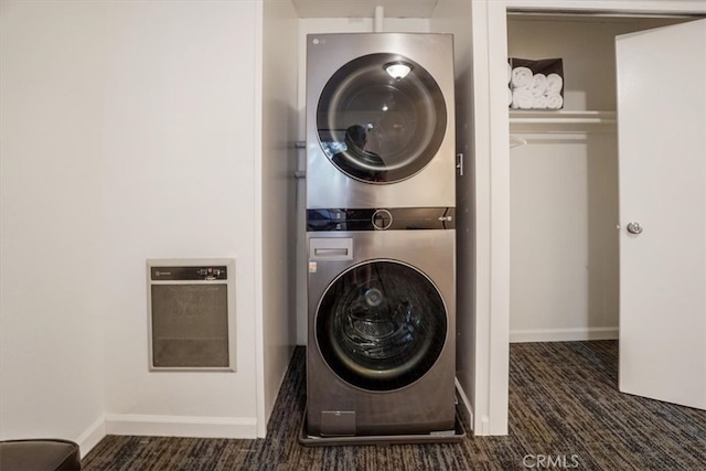 clothes washing area featuring dark colored carpet and stacked washer and dryer