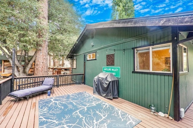 wooden terrace featuring area for grilling