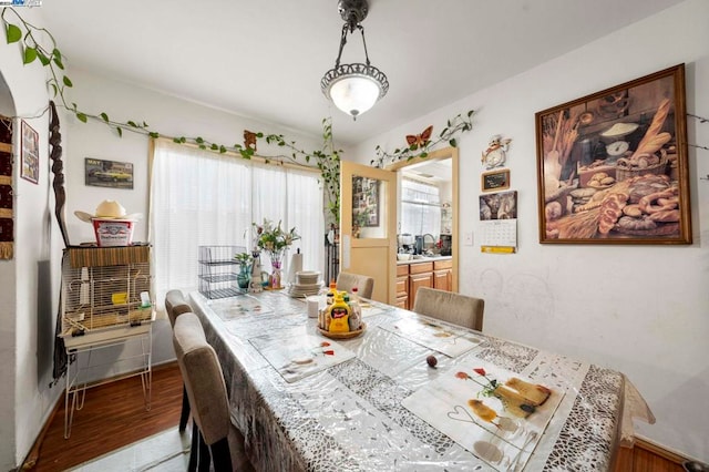 dining space with wood-type flooring