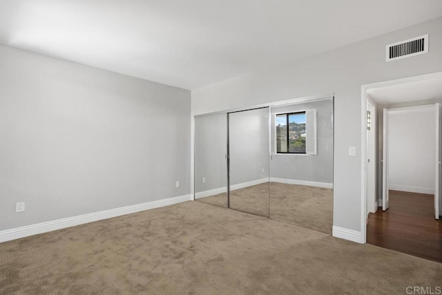 unfurnished bedroom with a closet and carpet flooring