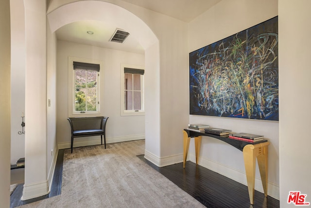 hallway with hardwood / wood-style flooring