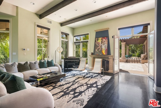 living room with plenty of natural light, beam ceiling, and wood-type flooring