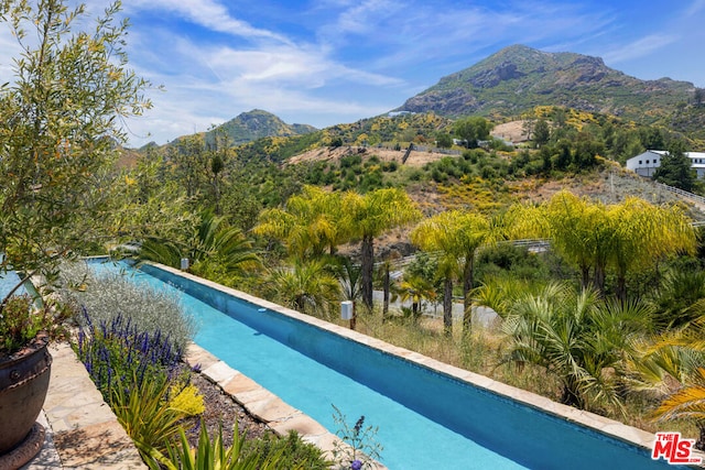 view of pool with a mountain view