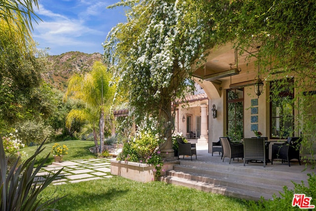 exterior space featuring a mountain view and a patio