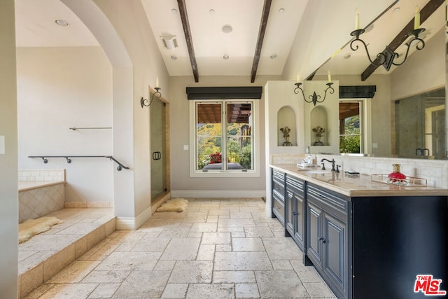 bathroom with separate shower and tub, plenty of natural light, vanity, and lofted ceiling with beams