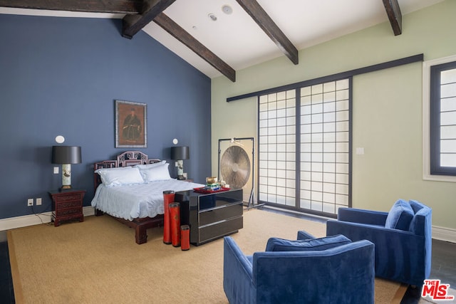 bedroom with lofted ceiling with beams and hardwood / wood-style flooring